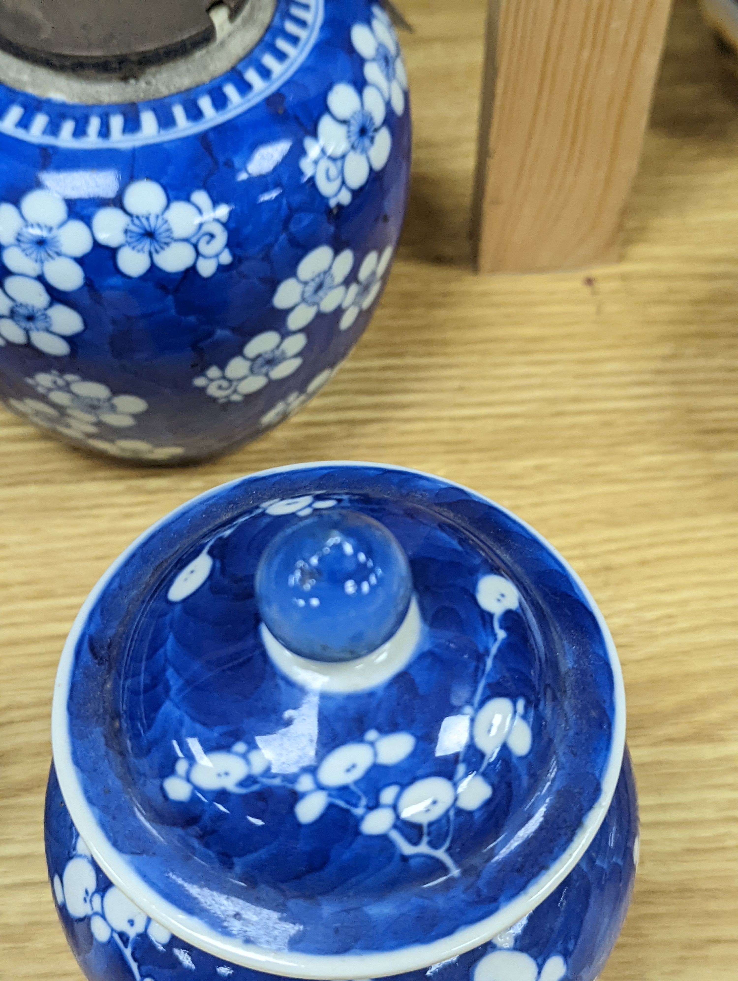 Three Chinese blue and white prunus decorated jars and covers, 19th/20th century, with four character marks 18cm
